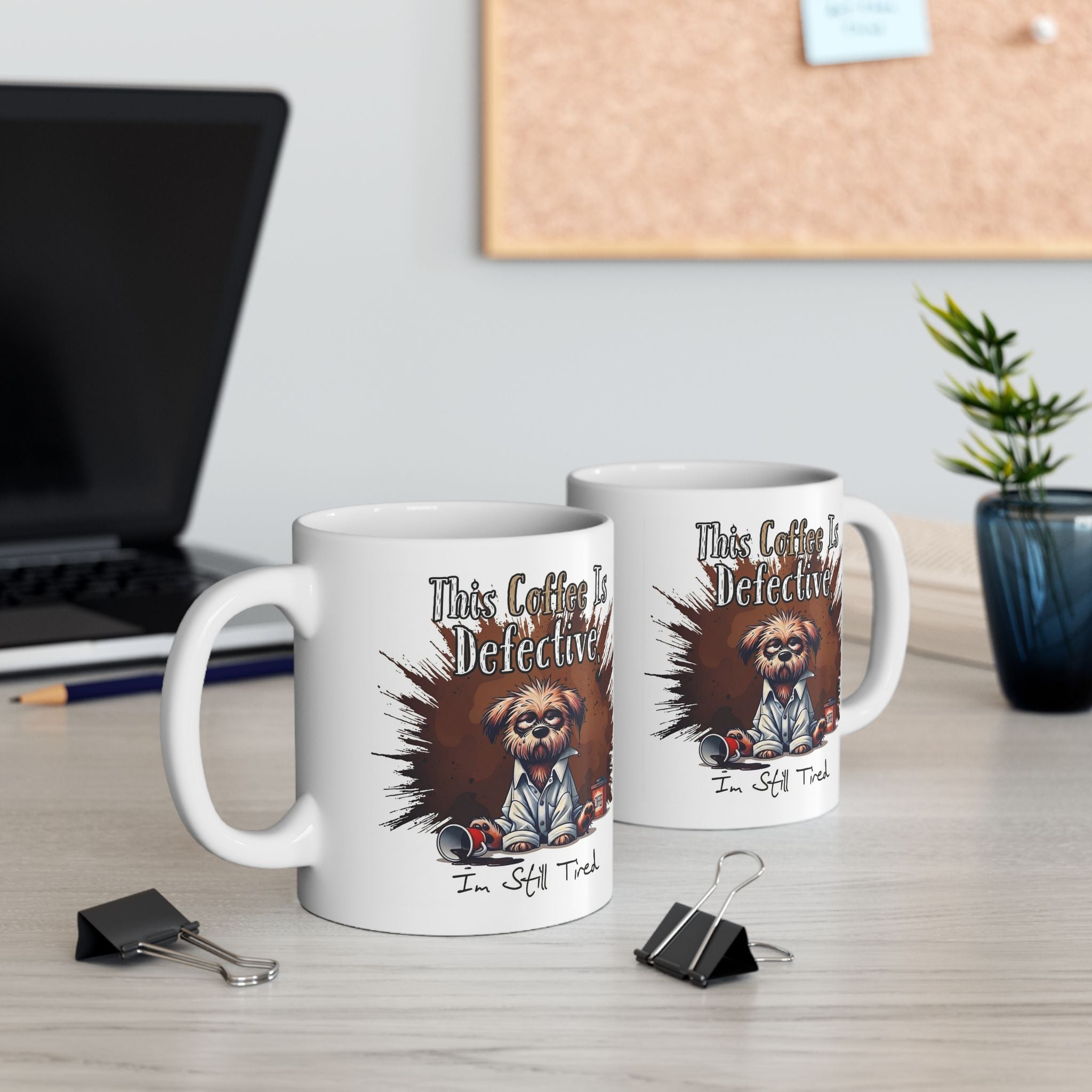 Two white ceramic mugs featuring a grumpy dog illustration and the text This Coffee Is Defective.
