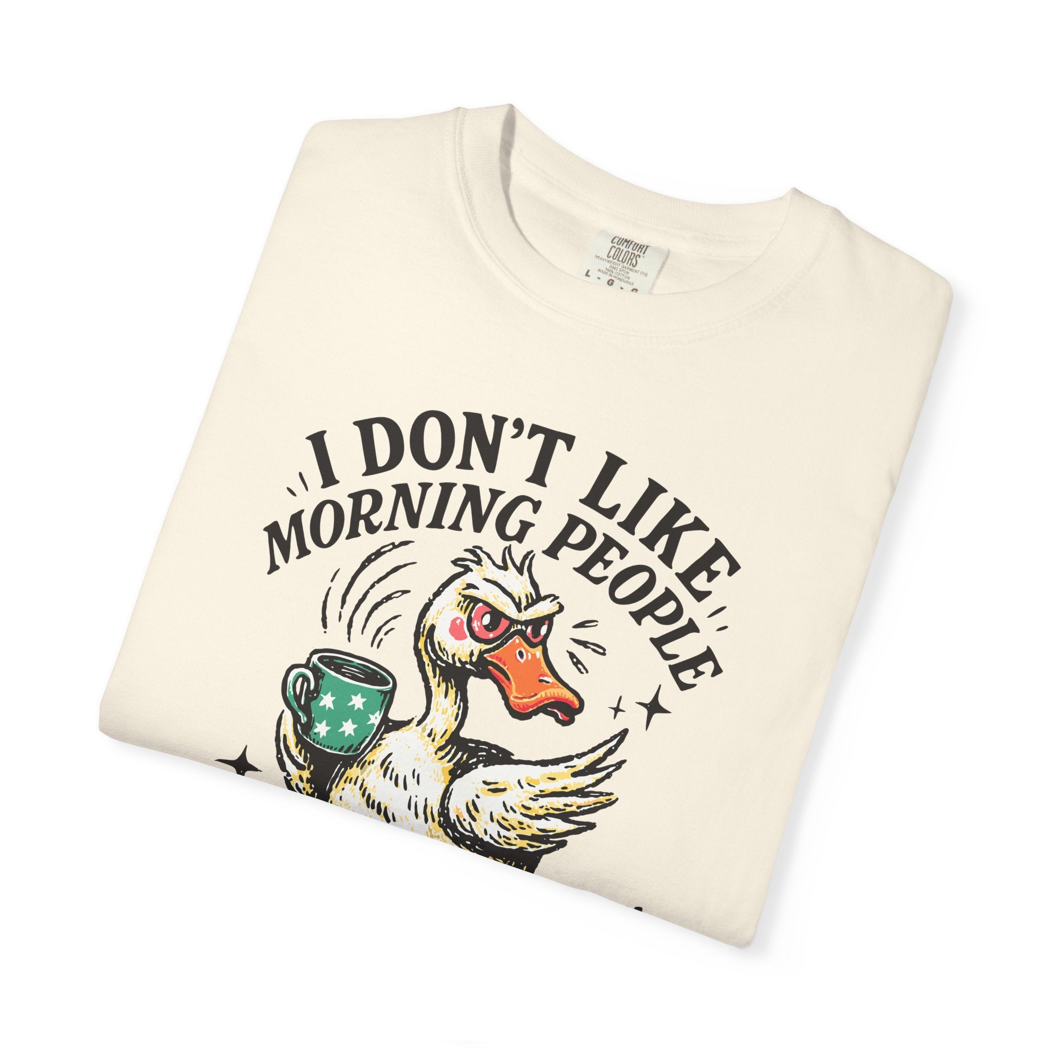 Cream-colored t-shirt featuring a graphic of an angry duck holding a coffee mug.