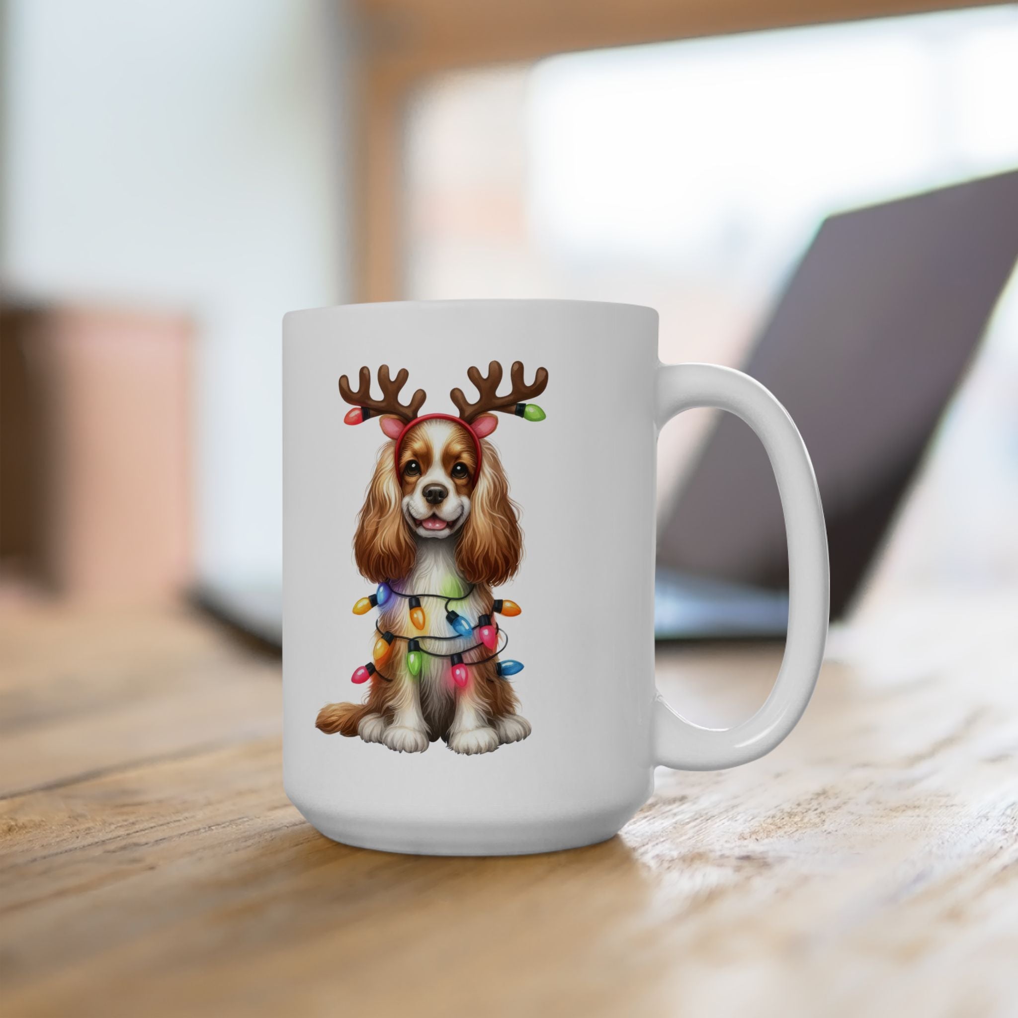 A white ceramic mug features an American Cocker Spaniel wearing reindeer antlers and Christmas lights.