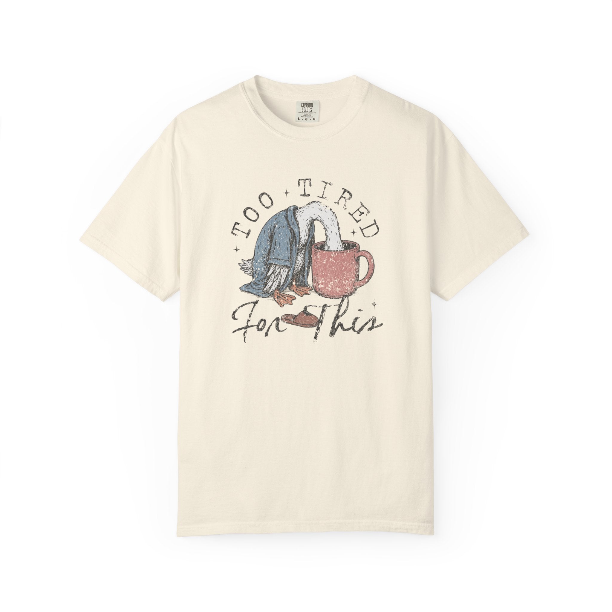 Cream-colored unisex t-shirt with a distressed graphic of a duck with its head in a coffee mug.