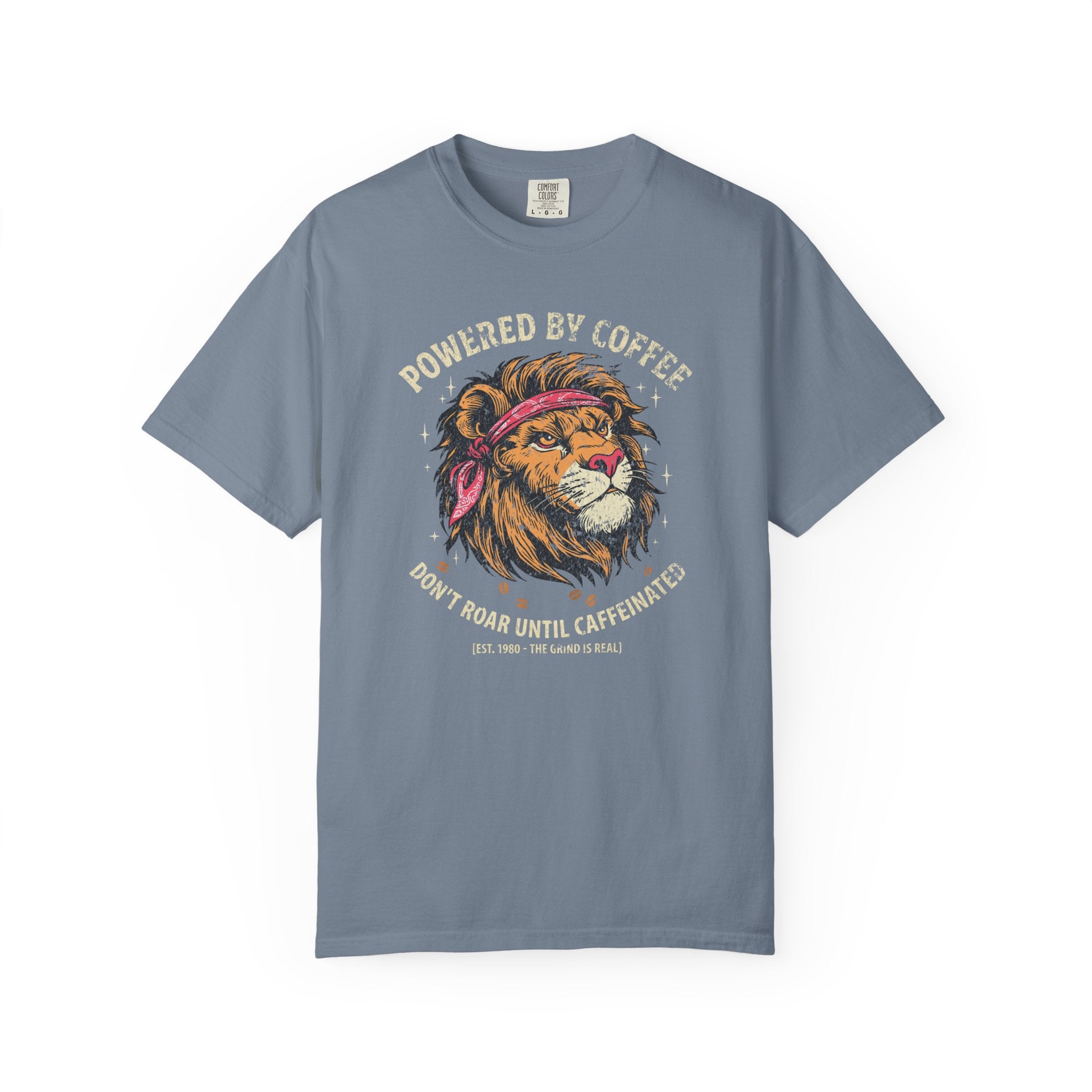 Blue t-shirt featuring a graphic of a lion wearing a bandana with the text Powered by Coffee.