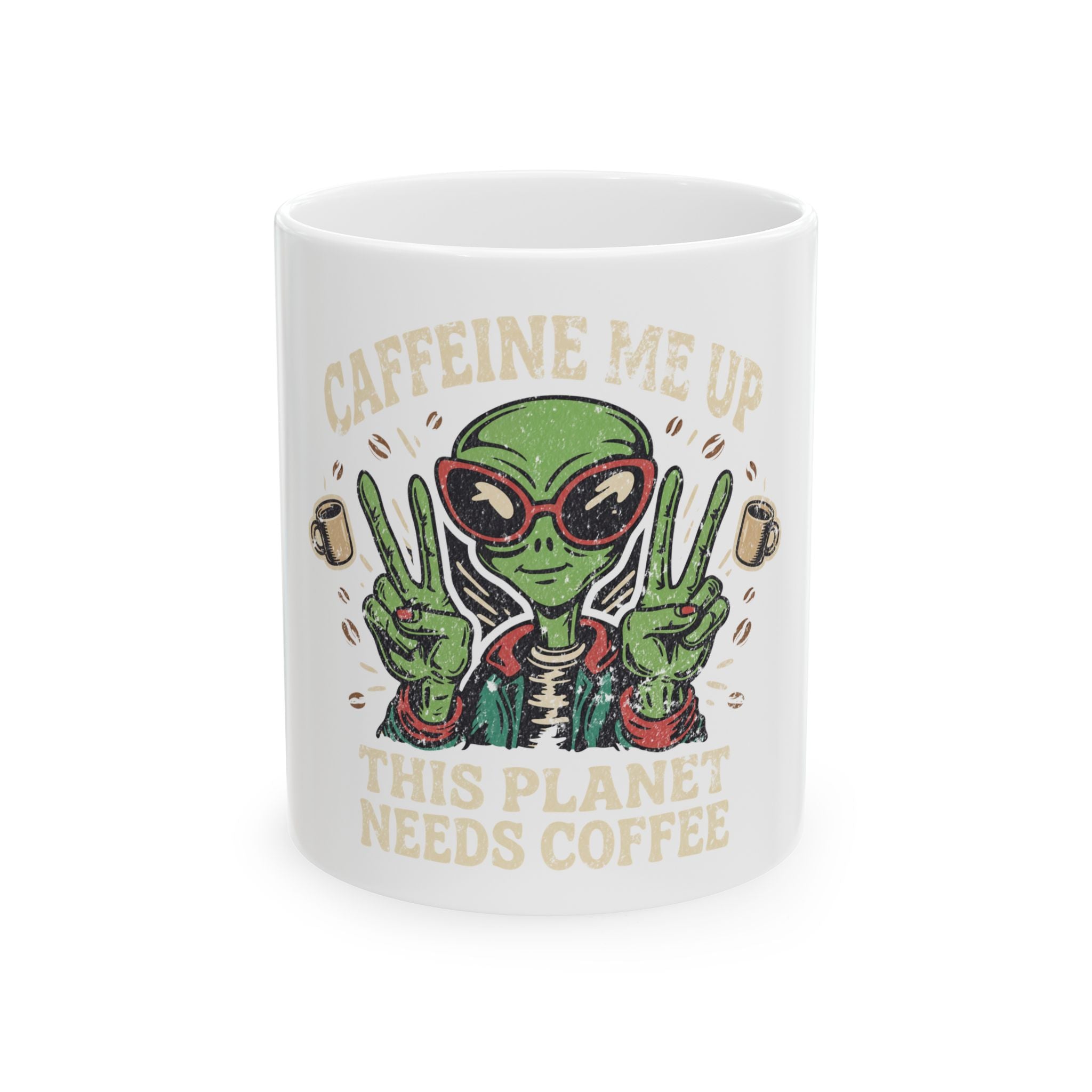 White ceramic mug featuring a green alien wearing sunglasses and making peace signs.