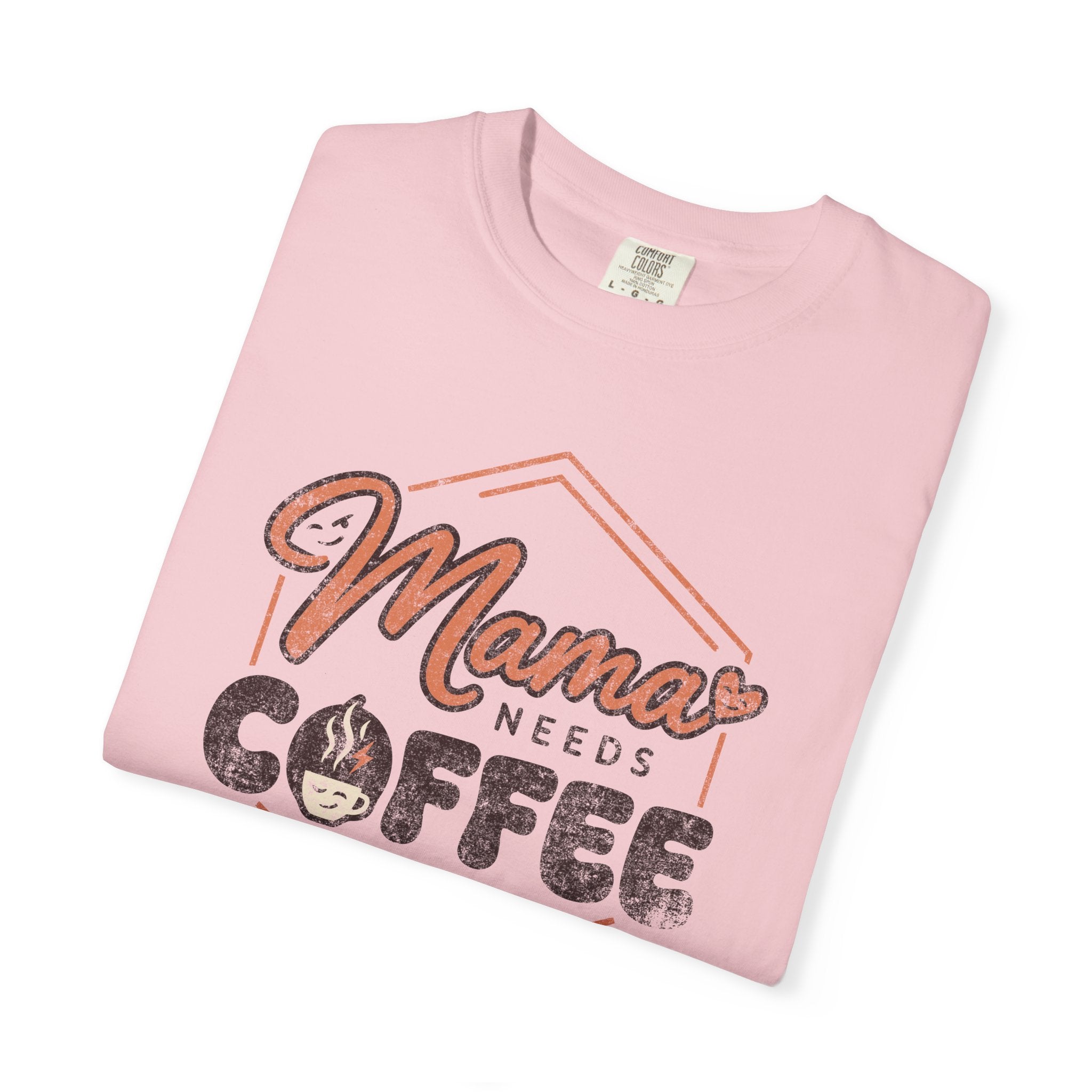 A light pink unisex t-shirt featuring a distressed graphic that says Mama Needs Coffee.