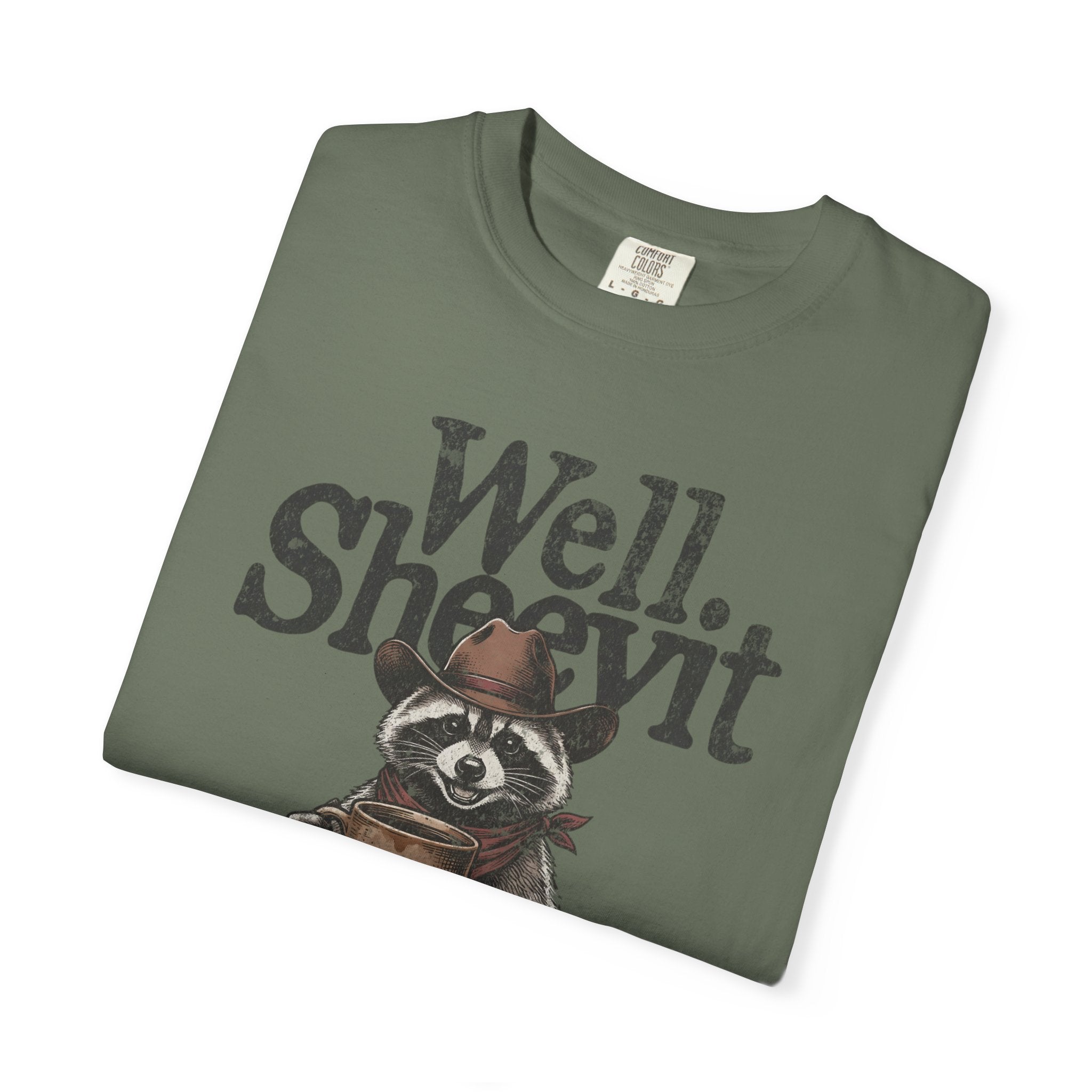 Olive green t-shirt featuring a graphic of a raccoon in a cowboy hat holding a coffee mug.