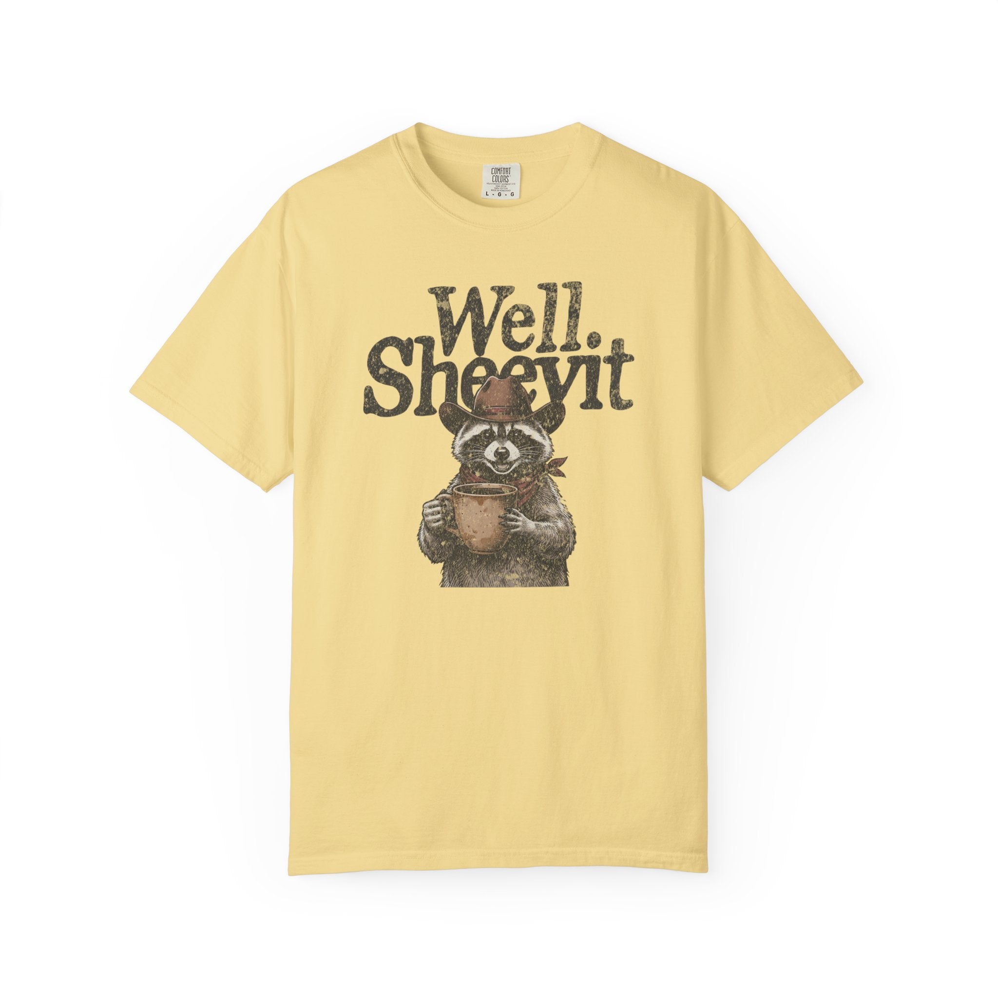 Light yellow t-shirt featuring a distressed graphic of a raccoon wearing a cowboy hat and scarf.
