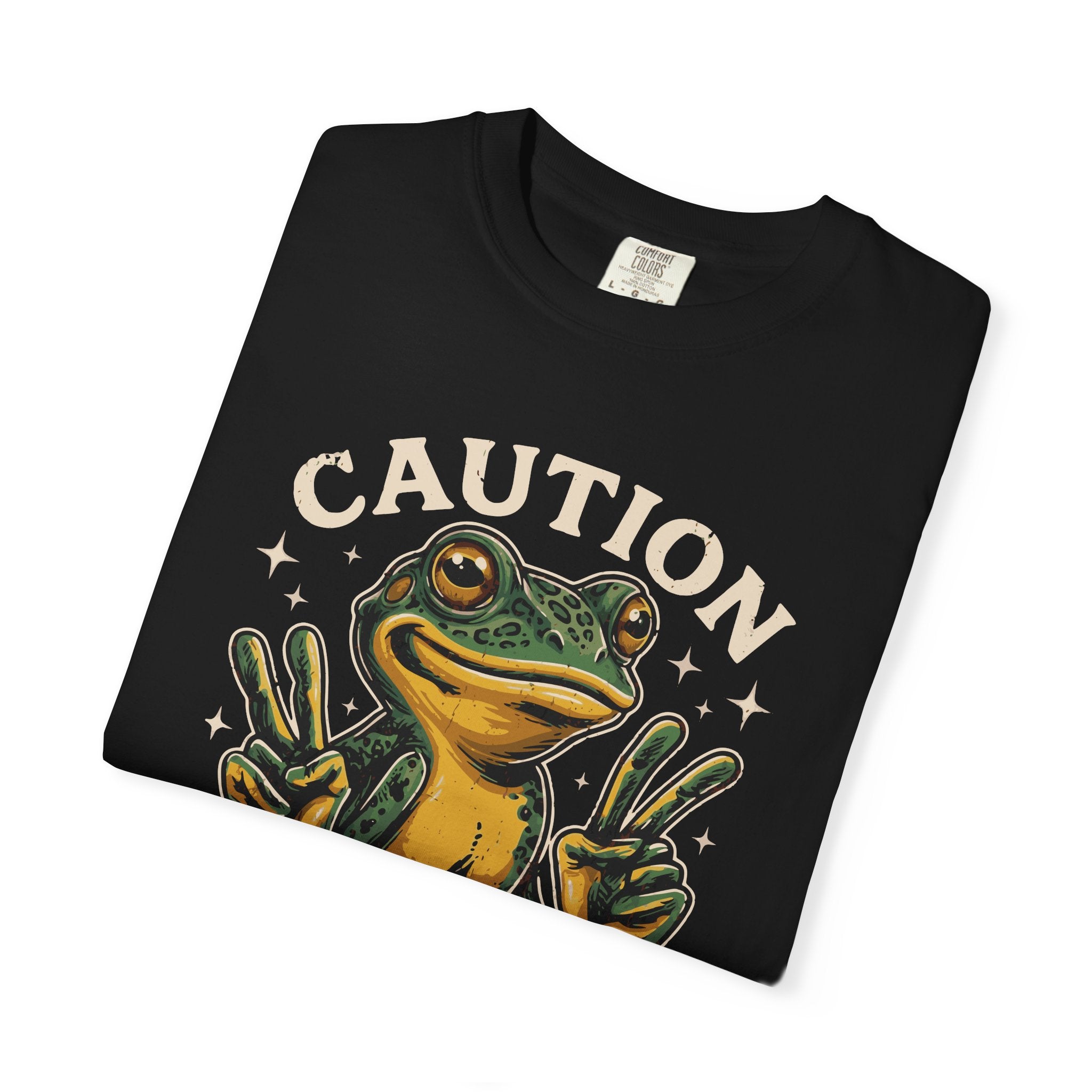 Black t-shirt featuring a graphic of a frog making peace signs with the word CAUTION above it.