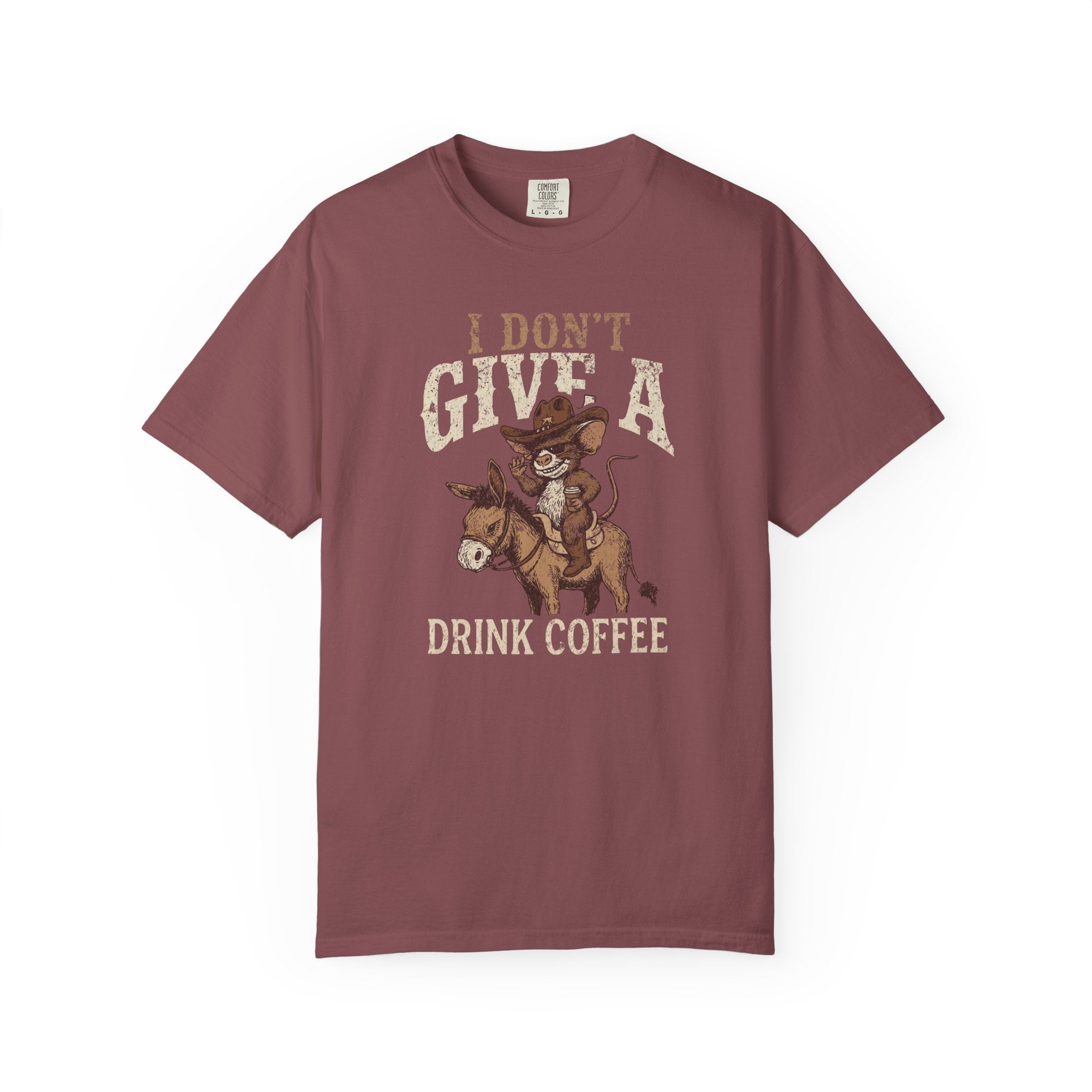 Maroon t-shirt with a graphic of a cowboy rat riding a donkey and holding a coffee cup.