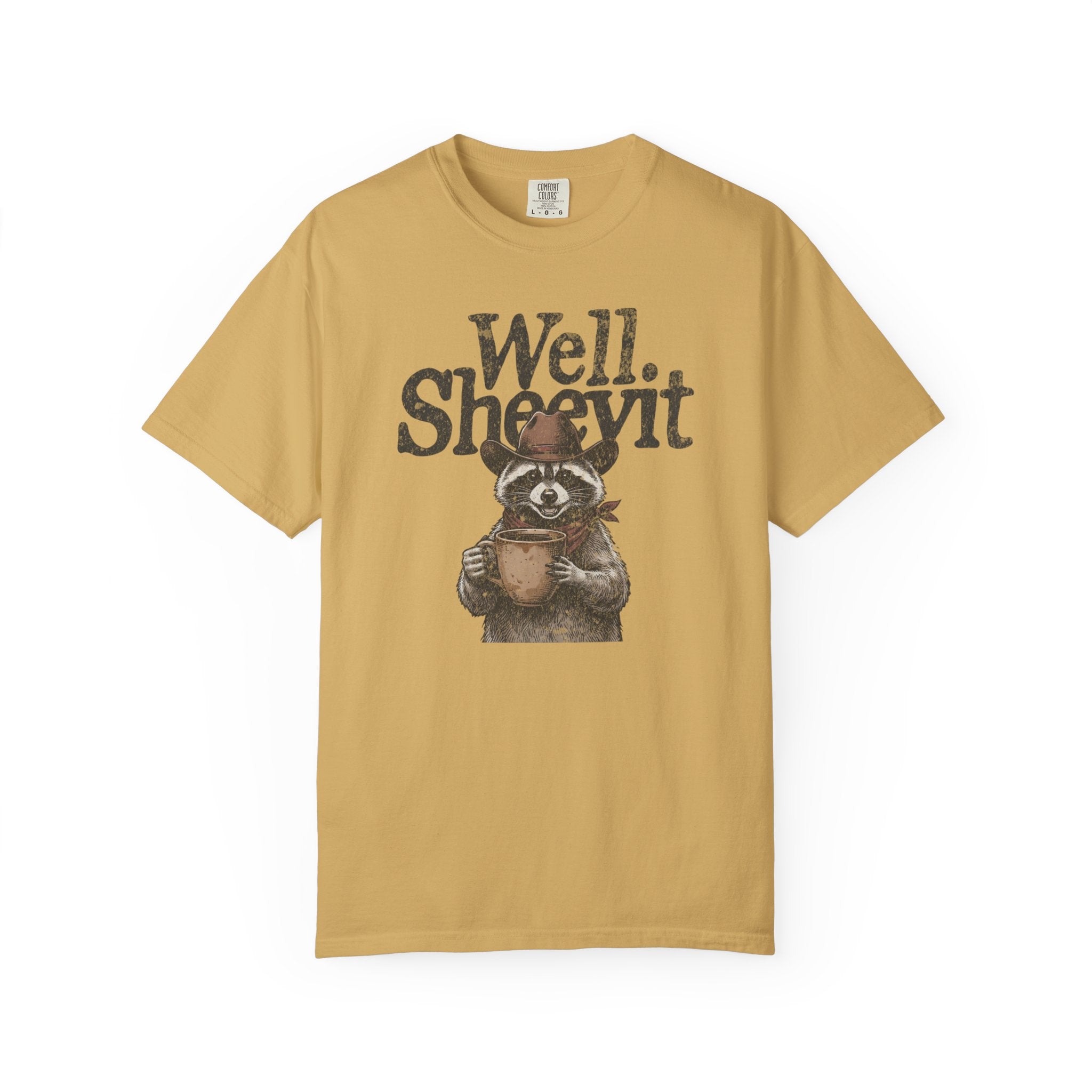 Mustard yellow t-shirt featuring a raccoon in a cowboy hat holding a coffee mug with text above.