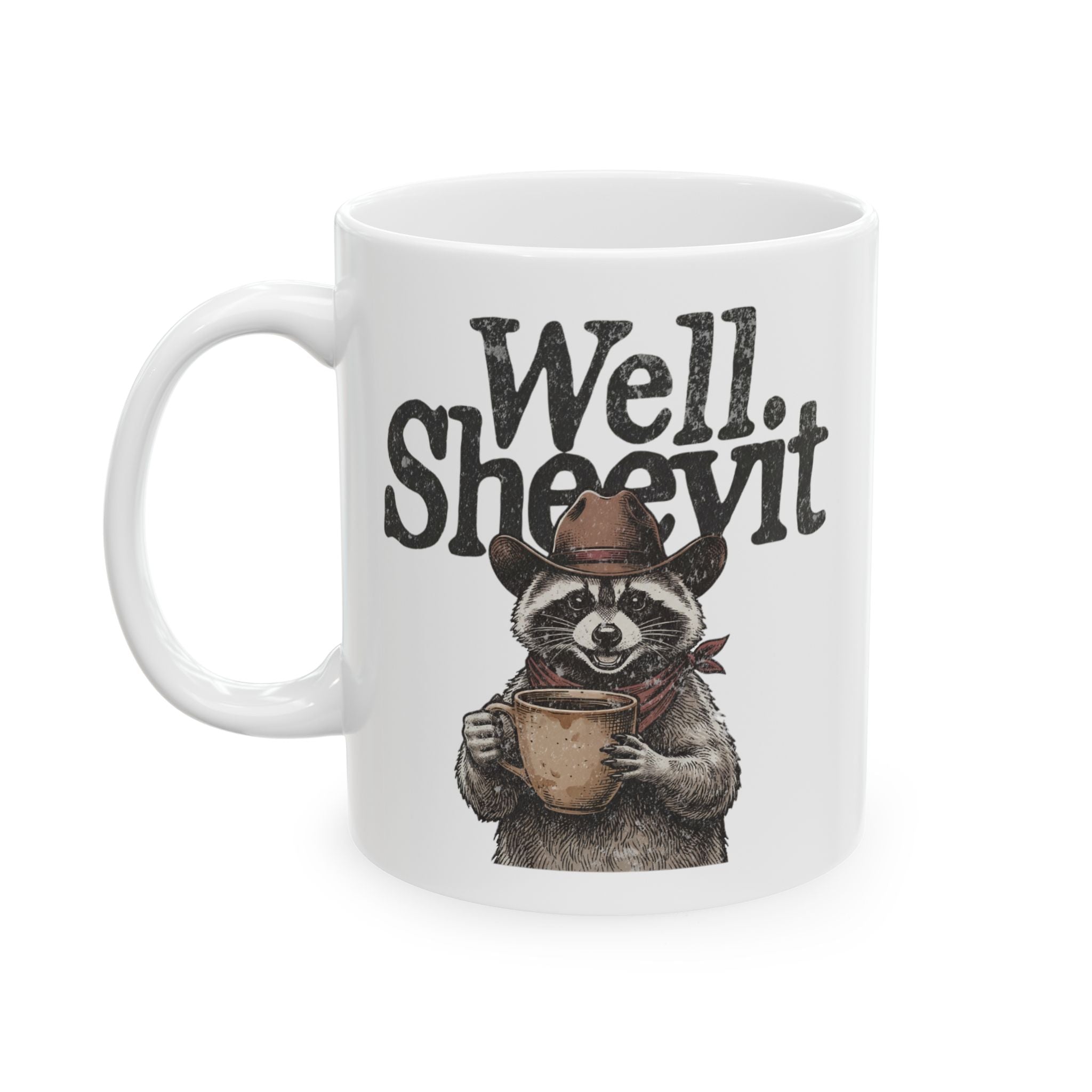 White 11oz ceramic mug featuring a cowboy raccoon holding a coffee cup with the text Well Sheevit.