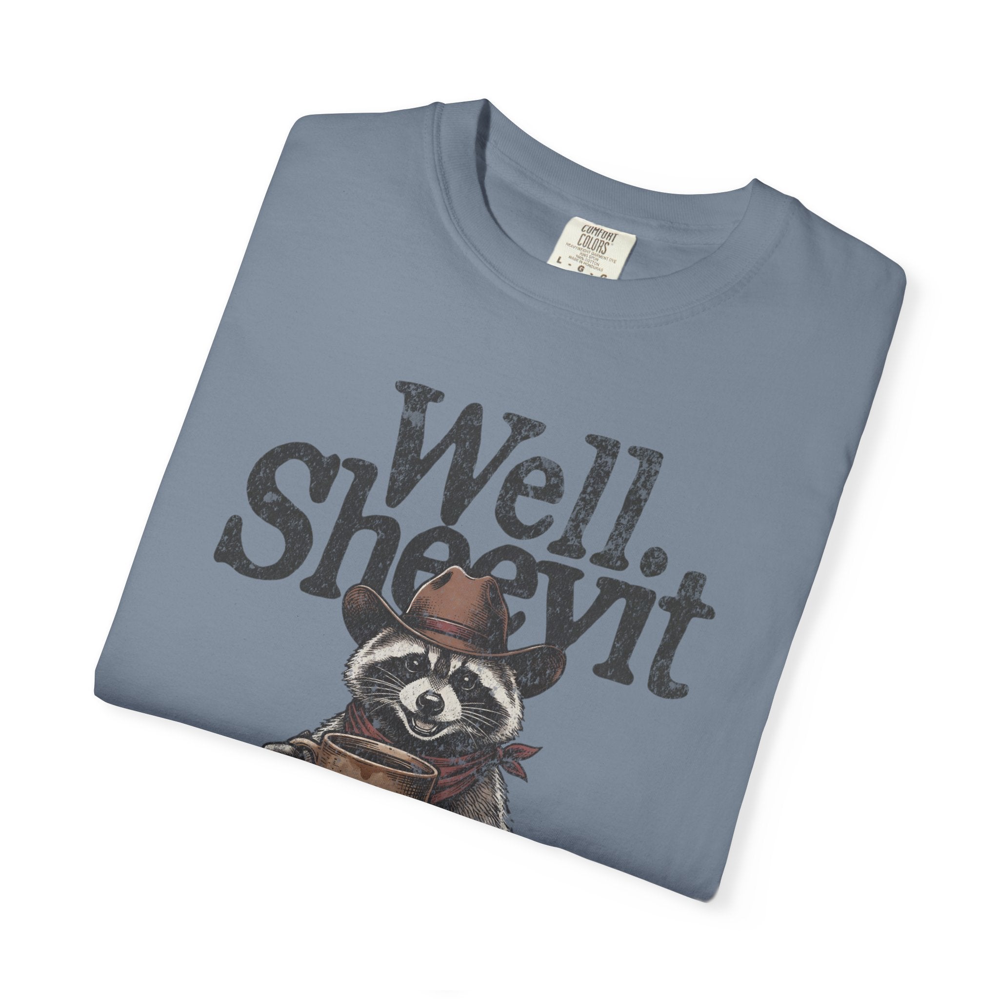 Blue t-shirt with a distressed graphic of a raccoon wearing a cowboy hat and holding a coffee mug.