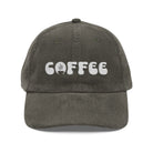 A dark grey corduroy dad hat with the word COFFEE embroidered in white on the front.
