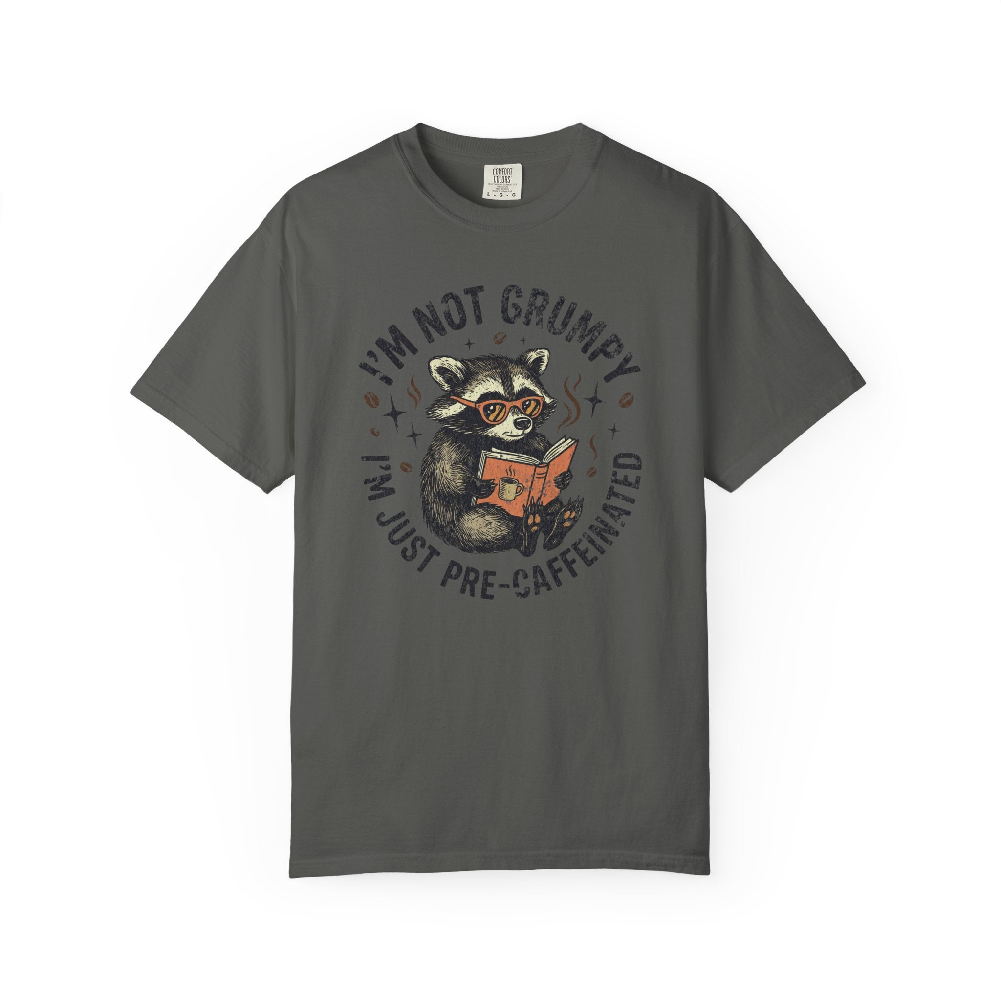 Dark grey t-shirt featuring a raccoon wearing glasses and reading a book with coffee text.