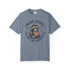 Blue unisex t-shirt featuring a graphic of a raccoon wearing glasses and reading a book.