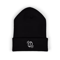 A black cuffed knit beanie featuring a small white embroidered coffee bean icon.