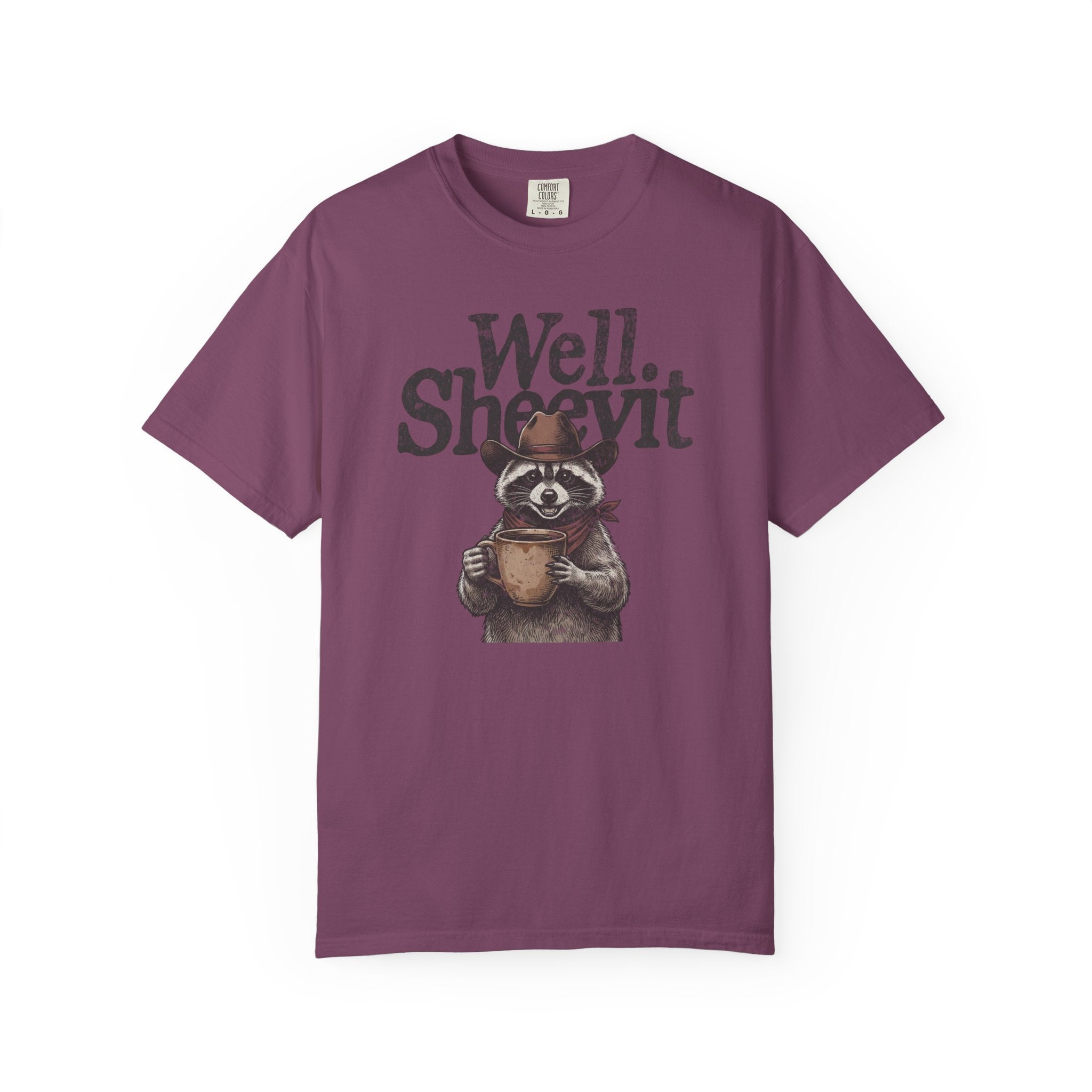 Purple t-shirt featuring a graphic of a raccoon wearing a cowboy hat and holding a coffee mug.