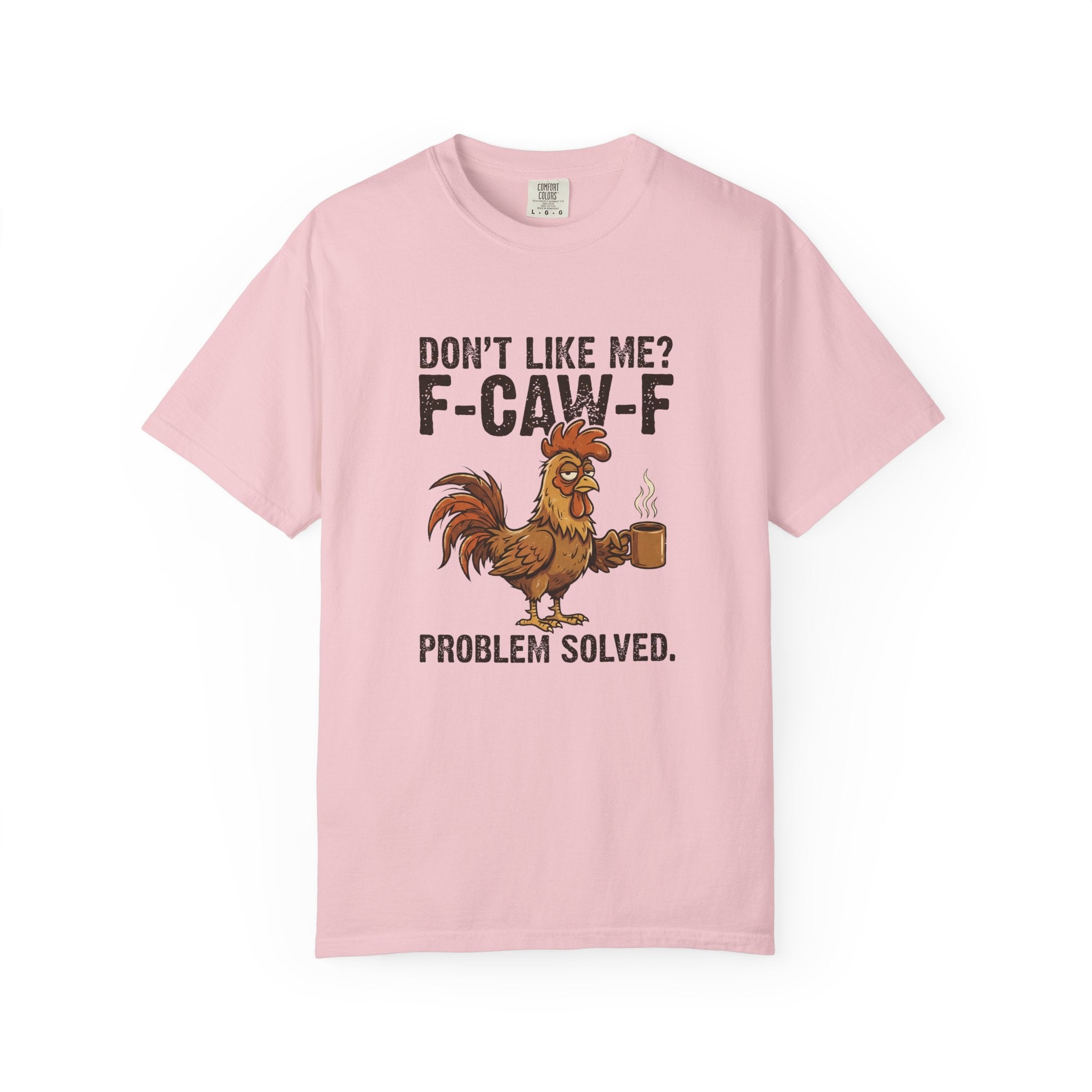 A light pink t-shirt featuring a graphic of a rooster holding a coffee mug with sarcastic text.