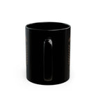 A black ceramic coffee mug with a retro pin-up design, viewed from the handle side.