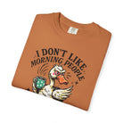 Orange t-shirt featuring a graphic of an angry duck holding a coffee mug with the text above it.