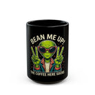 Black ceramic mug featuring a green alien wearing sunglasses and making peace signs.