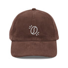 A brown corduroy dad hat featuring an embroidered white coffee bean icon on the front.
