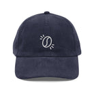A navy blue corduroy dad hat featuring an embroidered white coffee bean icon on the front.
