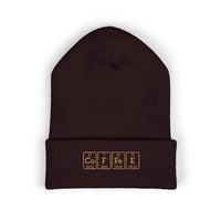 A dark brown cuffed beanie with "COFFEE" embroidered in periodic table style.