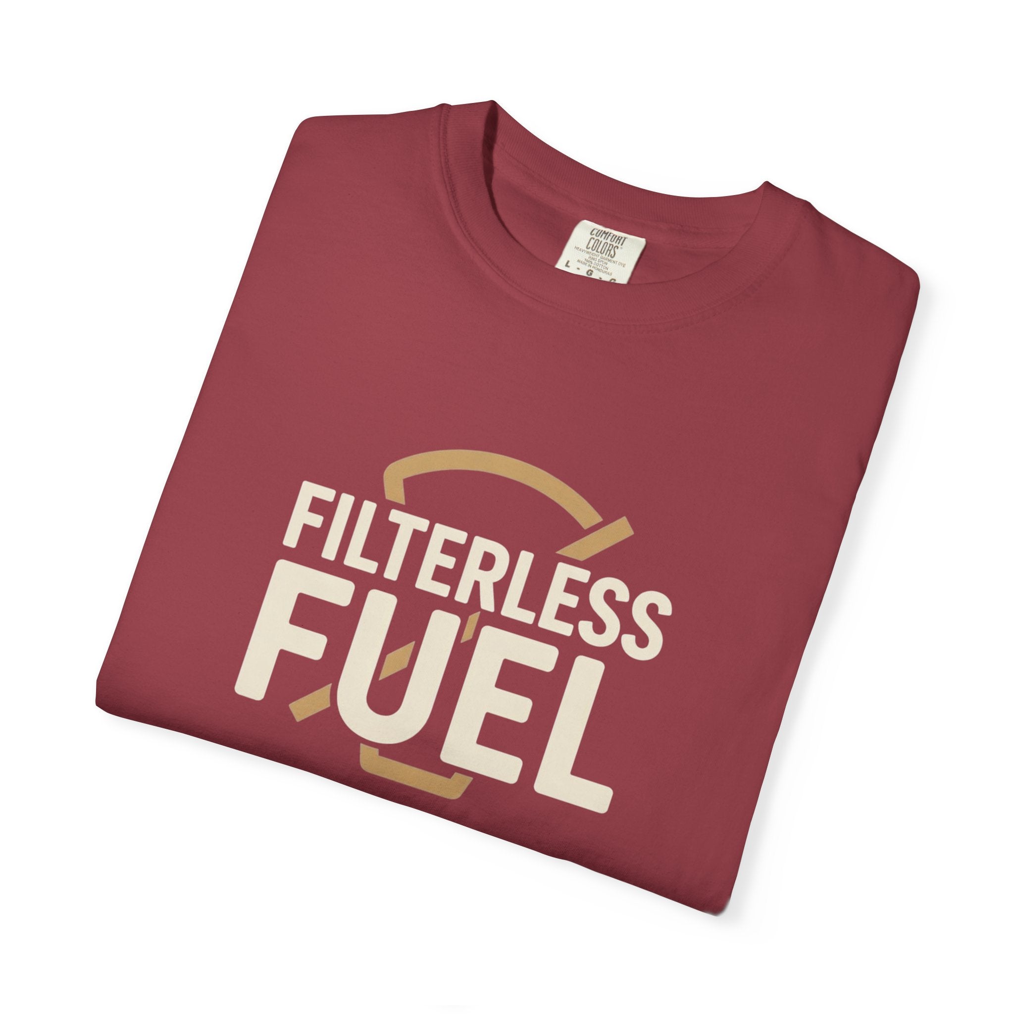 A folded maroon unisex t-shirt featuring the text Filterless Fuel in a retro cream font.