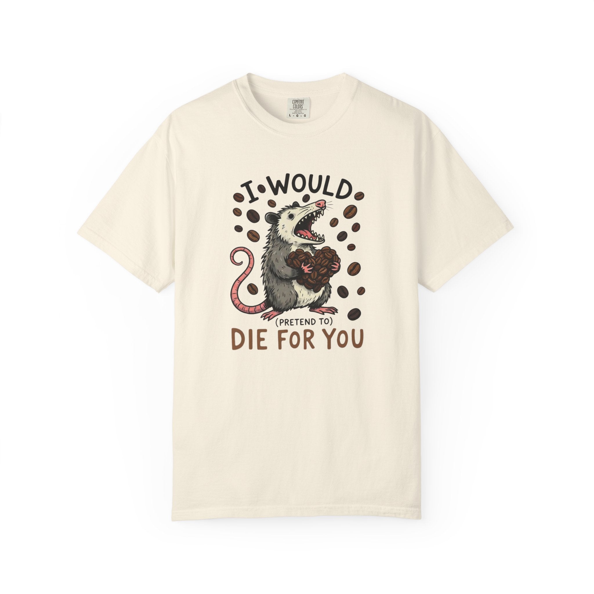 A cream-colored cotton t-shirt featuring a graphic of an opossum holding a heart of coffee beans.