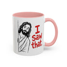 White ceramic mug with a pink handle and interior, featuring a drawing of Jesus and the text I Saw