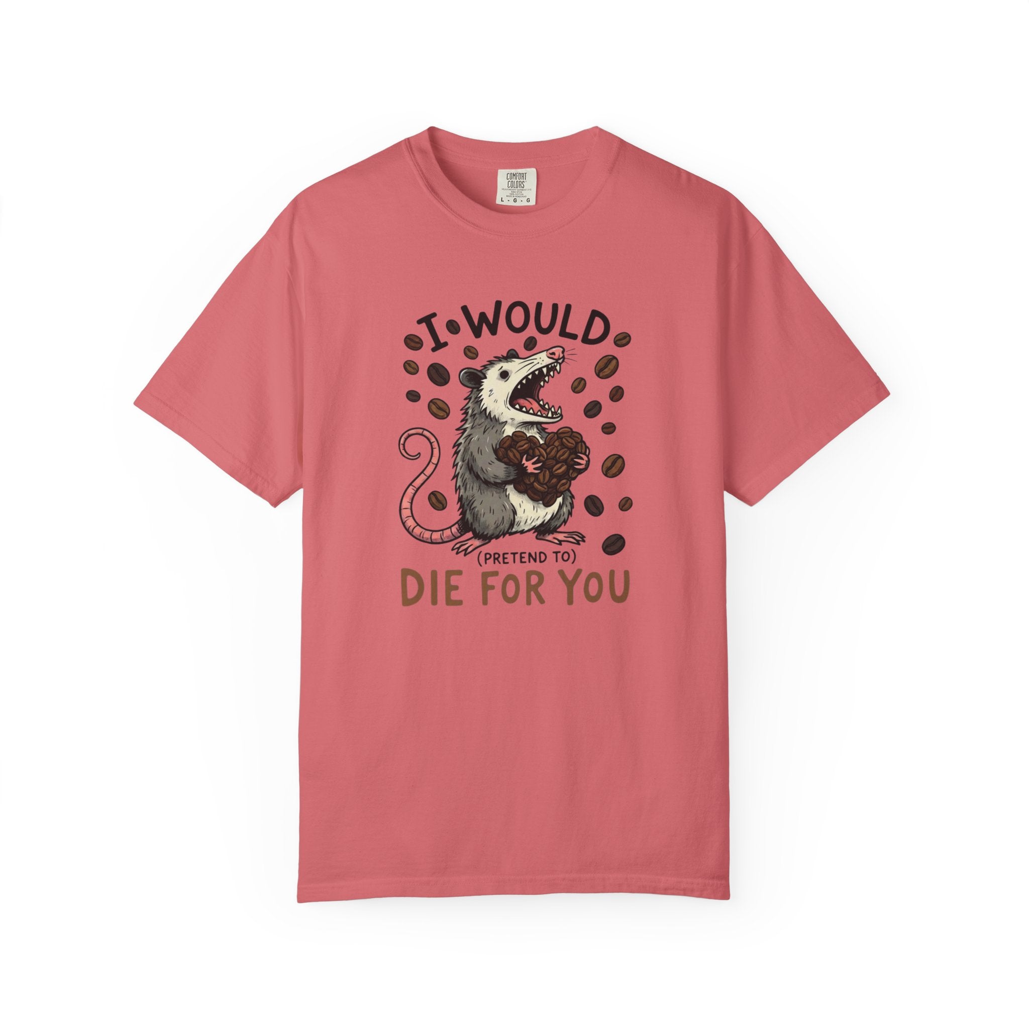 A dusty rose colored t-shirt featuring a graphic of an opossum holding a heart made of coffee beans.