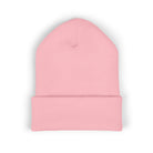 A pink cuffed knit beanie with a subtle embroidered coffee cup detail.