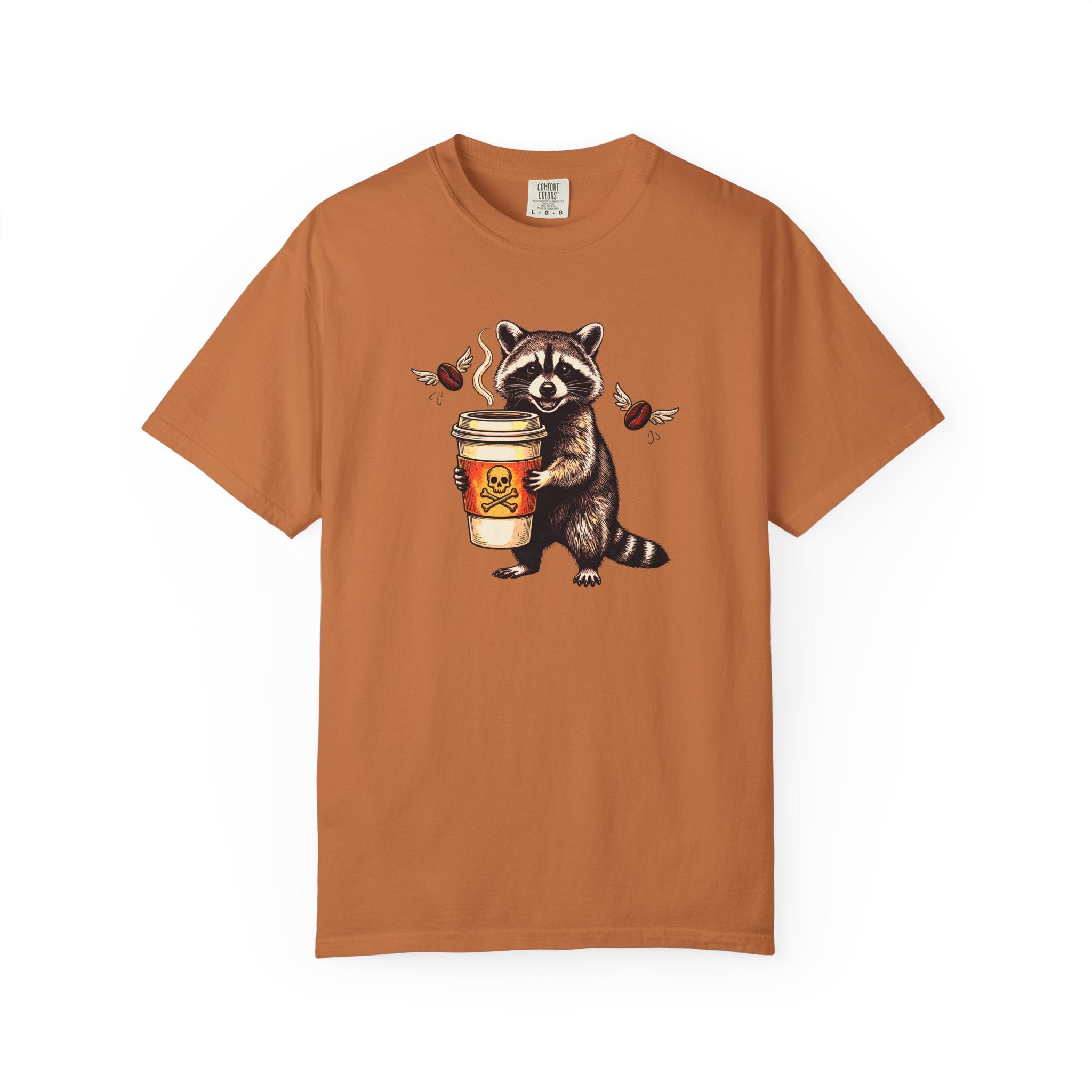 Rust-colored Comfort Colors unisex t-shirt featuring a raccoon holding a coffee cup with a skull.