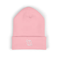 A light pink cuffed knit beanie featuring a small white embroidered coffee bean design.