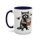 White ceramic mug with a dark blue handle and interior, featuring a raccoon holding a coffee cup.