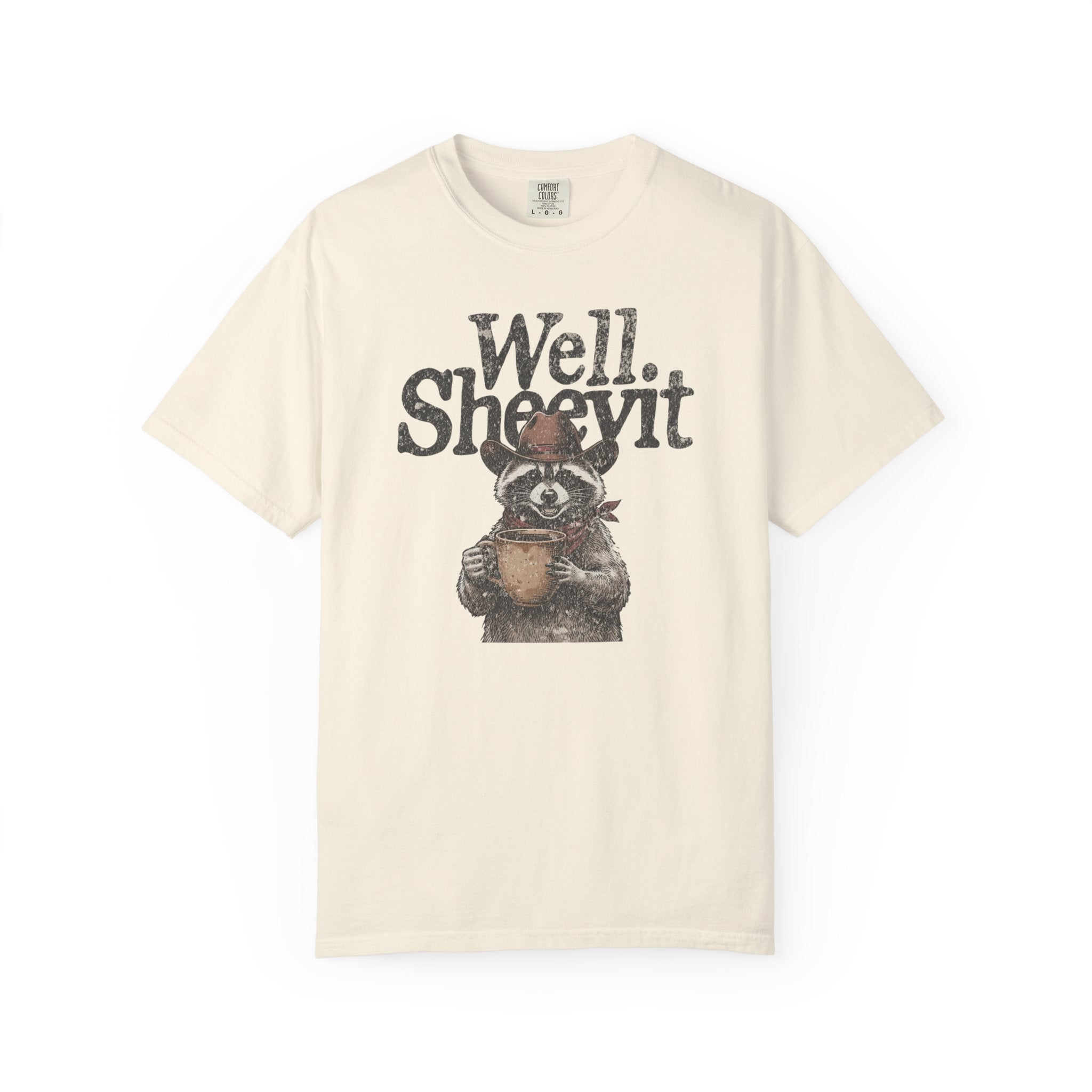 Cream-colored t-shirt featuring a distressed graphic of a raccoon wearing a cowboy hat and bandana.