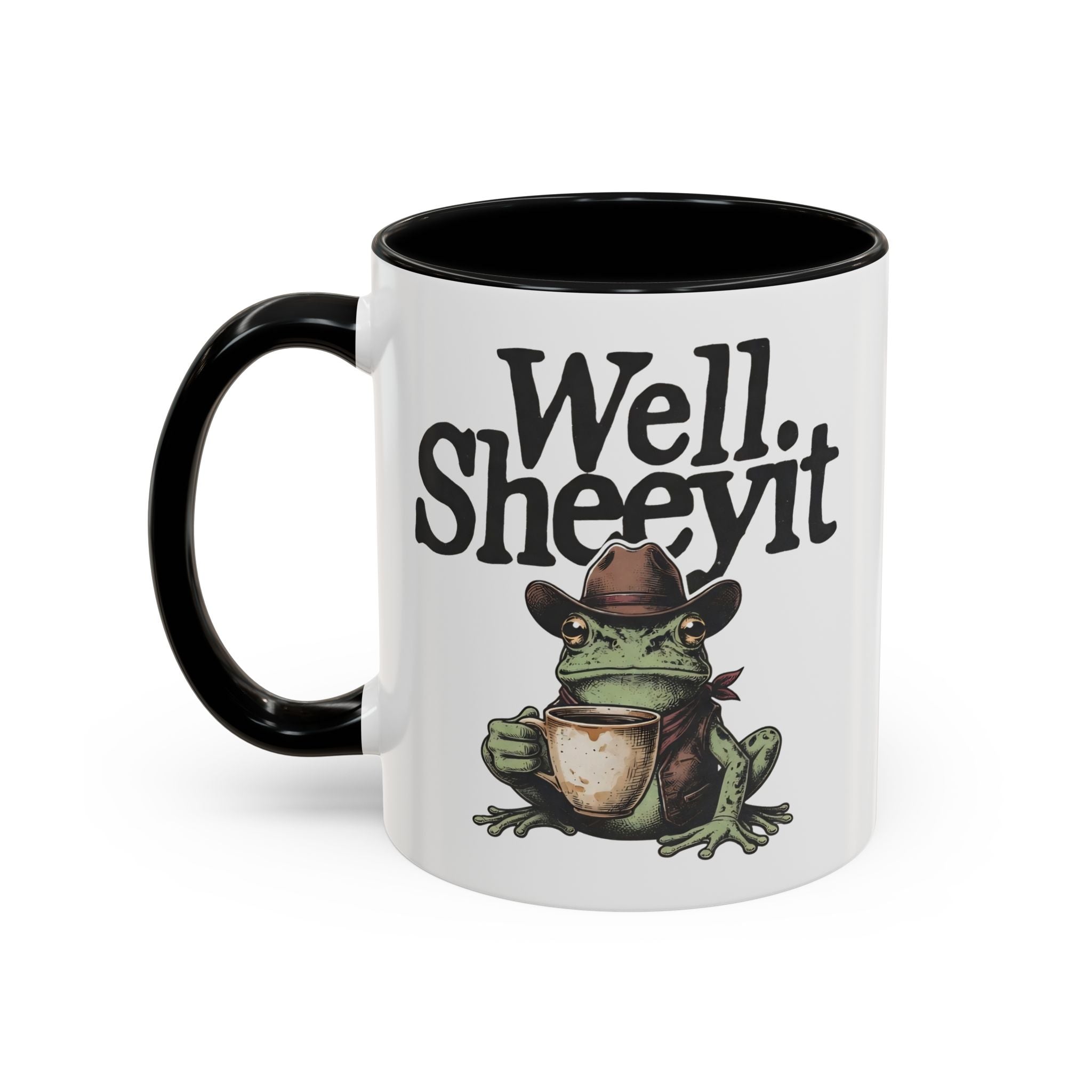 White ceramic mug with a black handle featuring a cowboy frog holding a coffee cup.