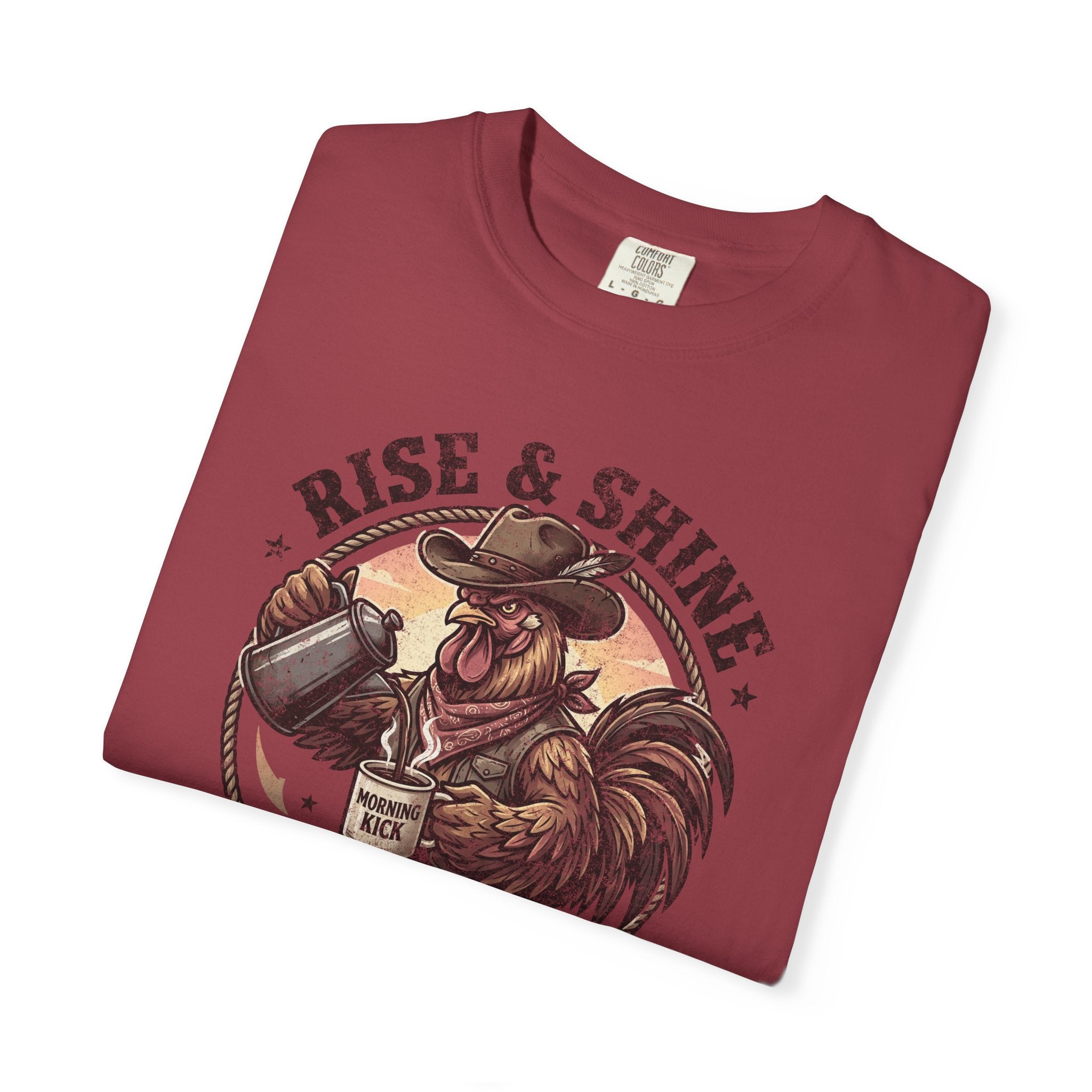 Red graphic t-shirt featuring a cowboy rooster pouring coffee with the text Rise & Shine.