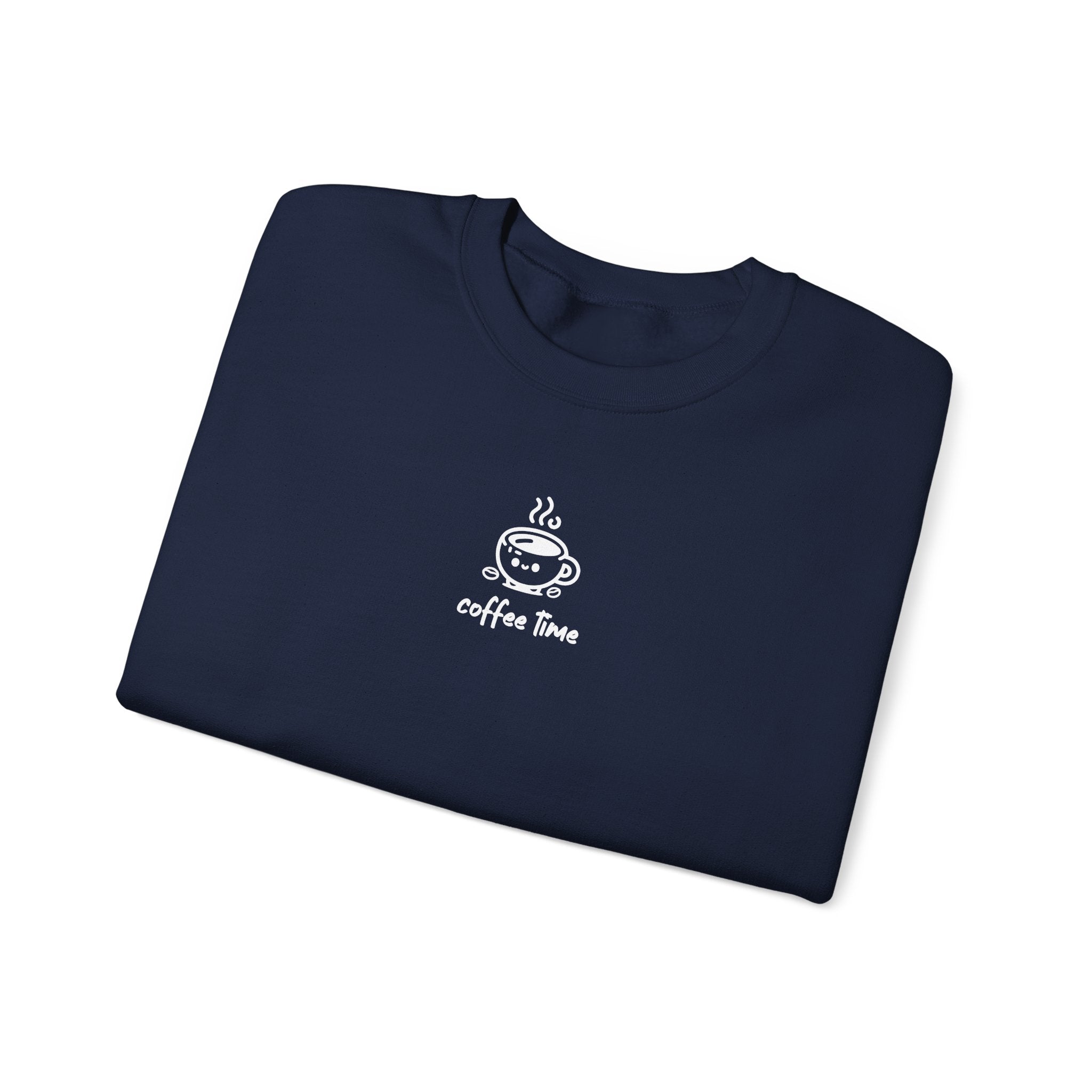 A folded navy blue crewneck sweatshirt featuring a small white graphic of a smiling coffee cup.