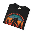 A black t-shirt featuring a vintage-style graphic of Bigfoot in a forest with the text I'm Hiding.