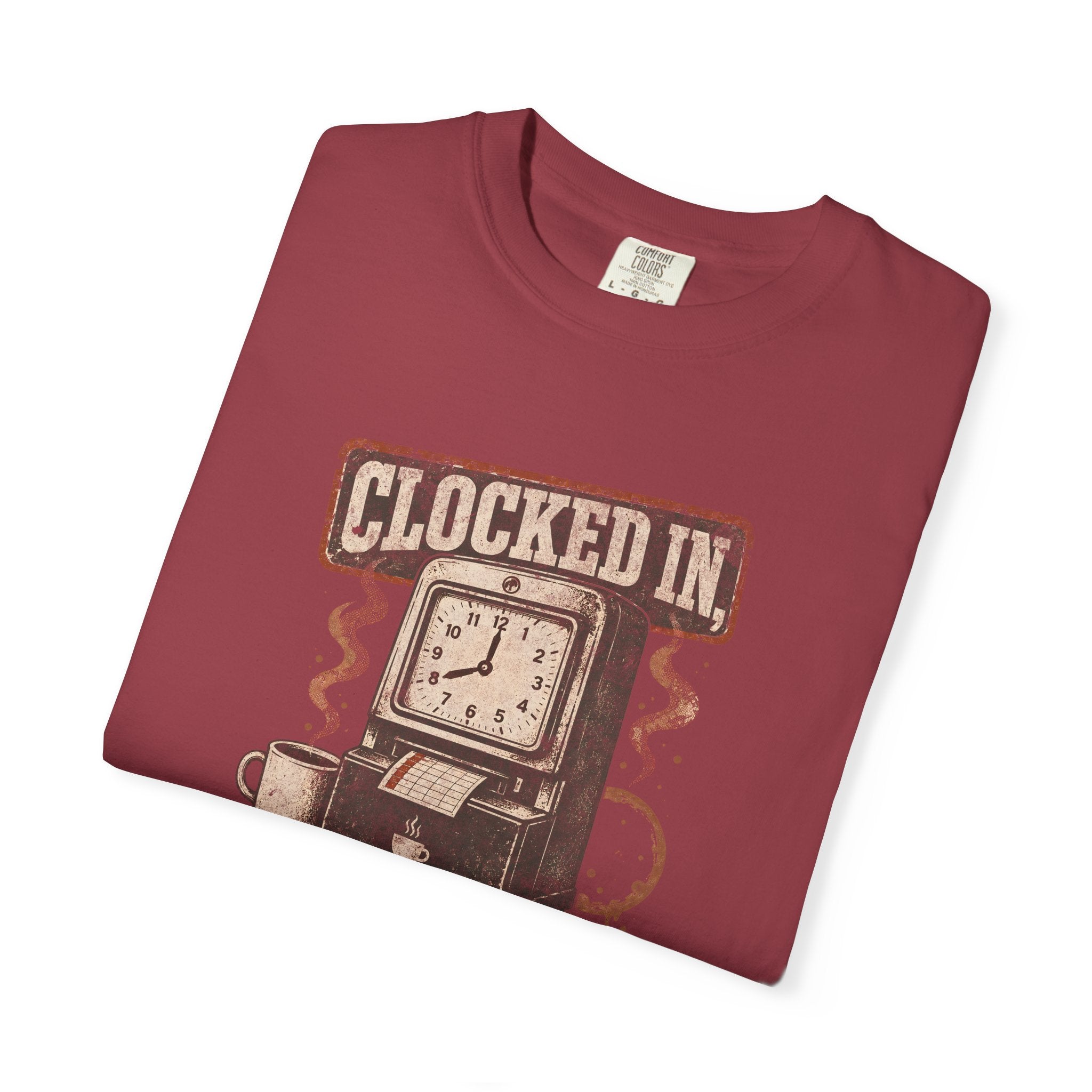 A folded maroon Comfort Colors t-shirt featuring a vintage clock and coffee graphic.
