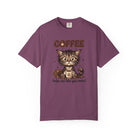 A purple unisex t-shirt featuring a cute kitten holding a coffee mug with the text Coffee helps me.