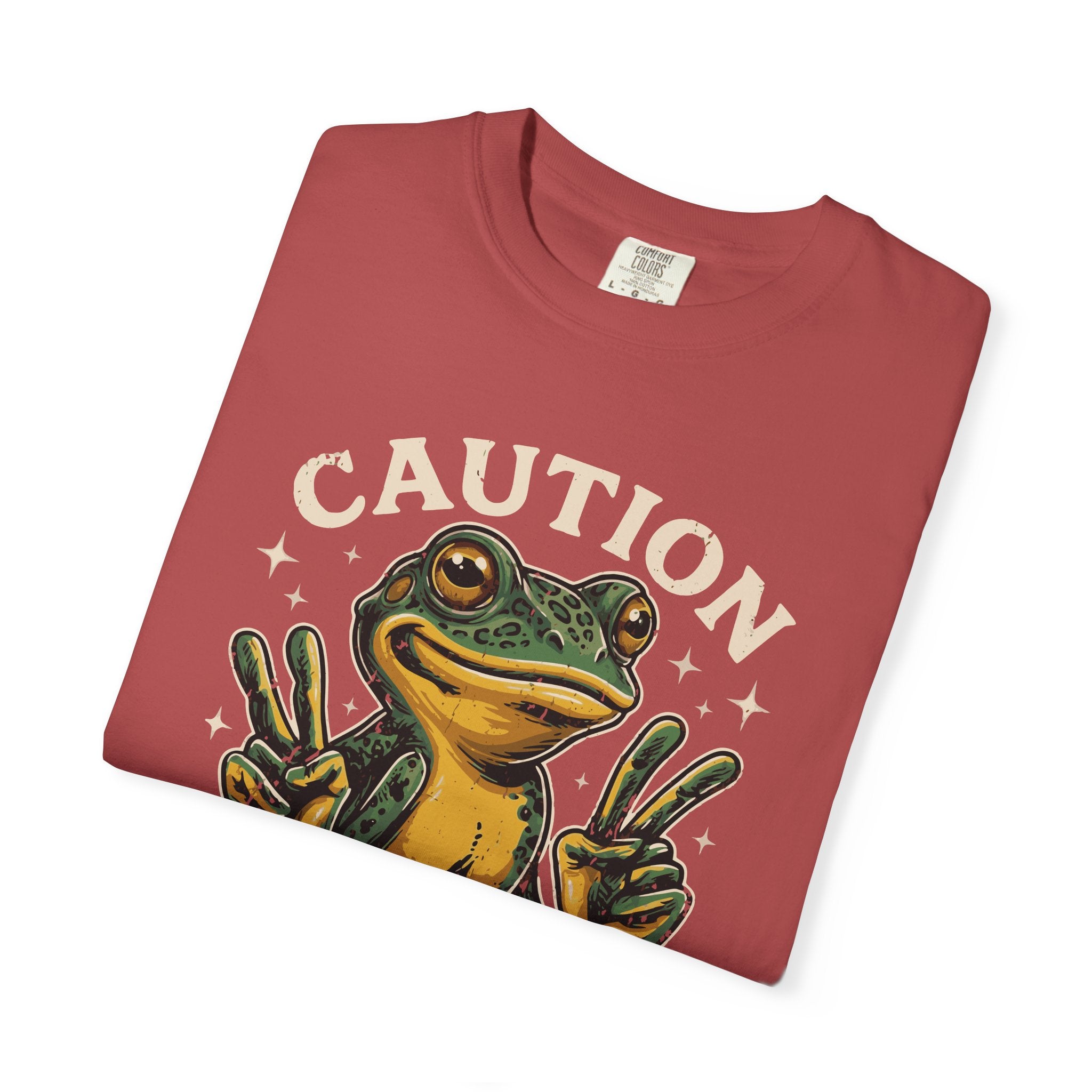 Red t-shirt featuring a cartoon frog making peace signs with the text CAUTION above it.