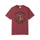 Red unisex t-shirt featuring a graphic of a raccoon wearing glasses and reading a book.