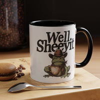 White ceramic mug featuring a cowboy frog holding a coffee cup with the text Well Sheeyit.
