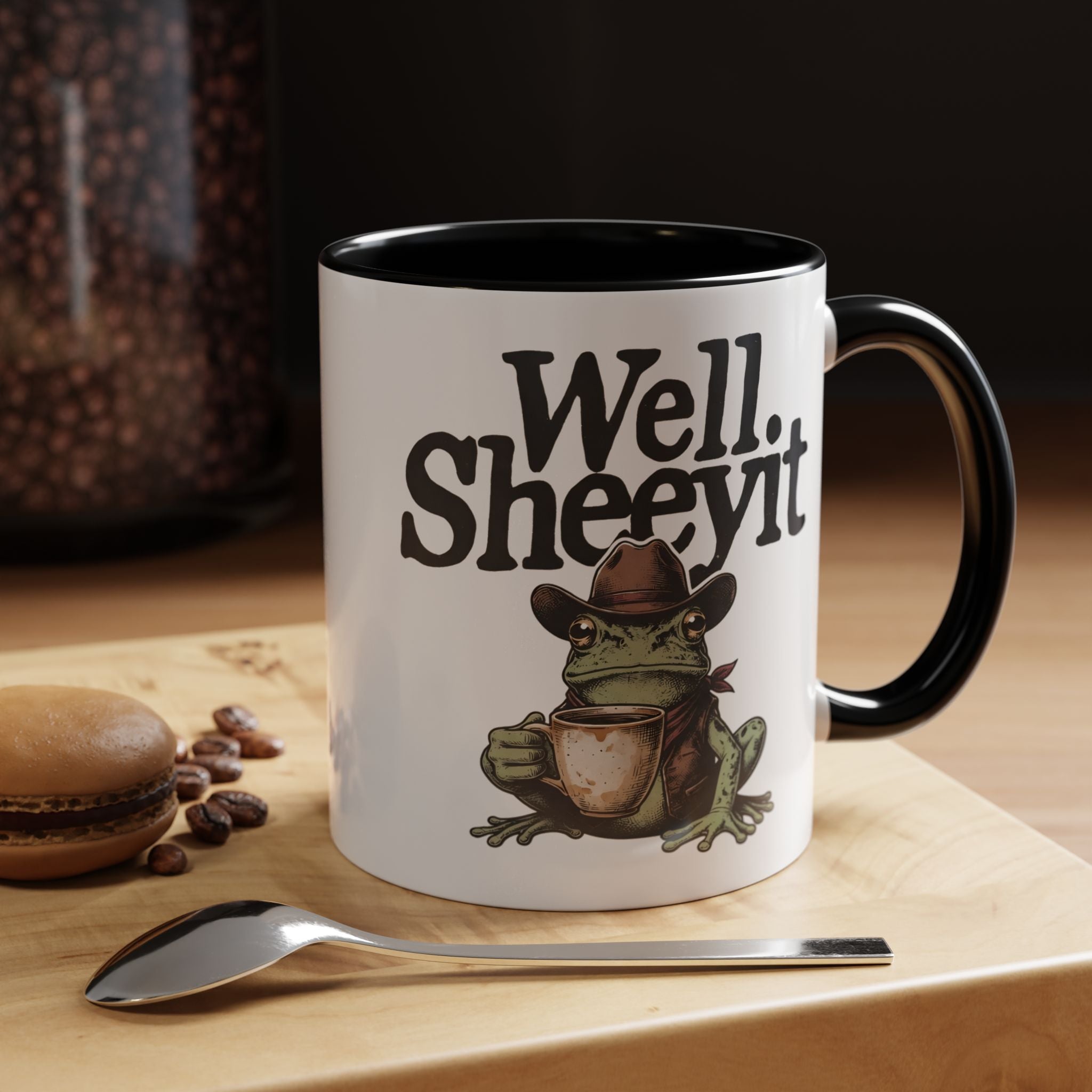 White ceramic mug featuring a cowboy frog holding a coffee cup with the text Well Sheeyit.