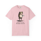 A light pink cotton t-shirt featuring a graphic of a frog holding a coffee mug with the text I HAVE TO SAY WEIRD STUFF.