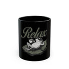 Black ceramic coffee mug featuring a graphic of a frog wearing sunglasses and holding a cup.