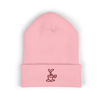Pink cuffed knit beanie with an embroidered coffee cup design.