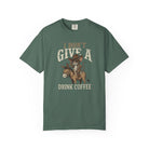 Green unisex t-shirt with a distressed graphic of a cowboy rat riding a donkey holding coffee.