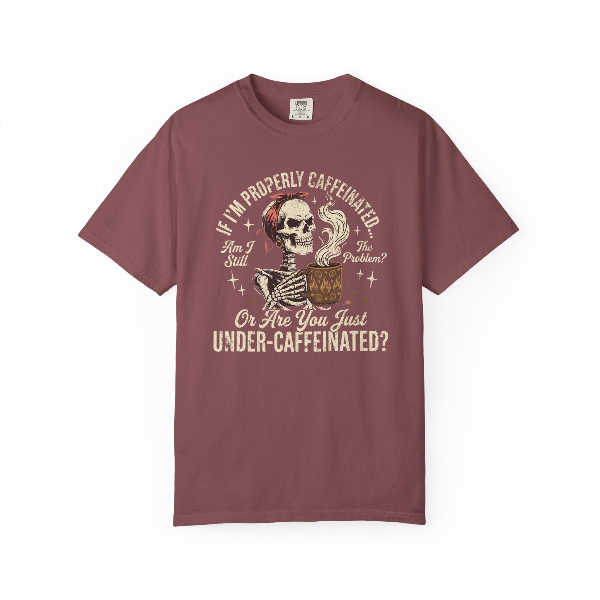 A maroon t-shirt featuring a skeleton wearing a red bandana and holding a steaming coffee mug.